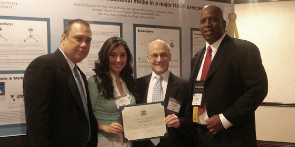 John Williams, Marilu Ramirez, and John Williams posing with award
