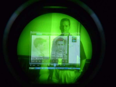 Looking into night vision scope with person's data viewed