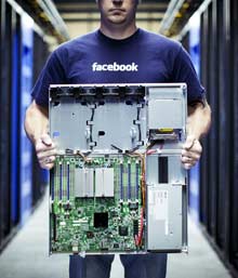 A Facebook employee shows one of the servers that the company’s engineers designed from scratch for its massive data center in Oregon. 