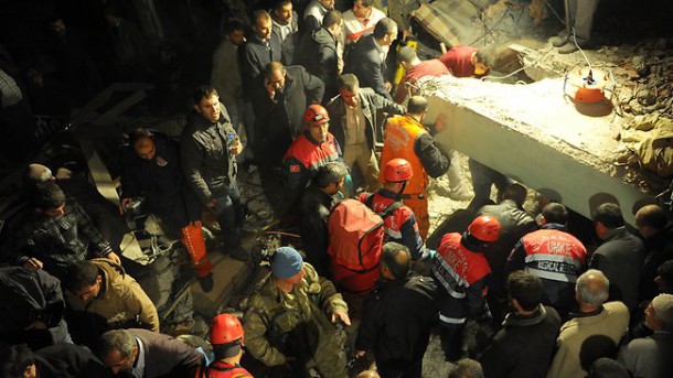 rescue workers try to save people from a collapsed building